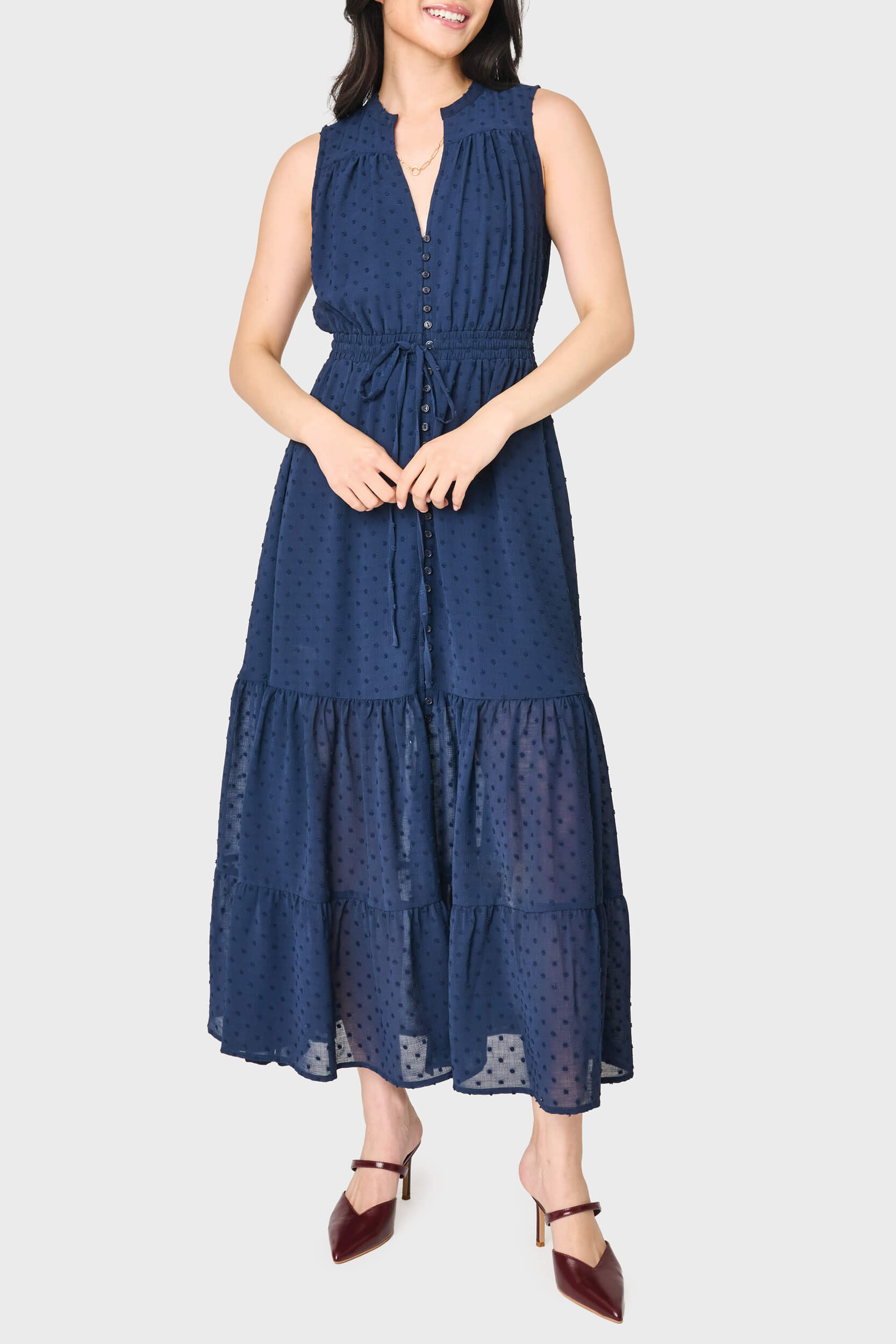woman modeling Kira Sleeveless Drawstring Midi Dress in Navy styled for work and everyday