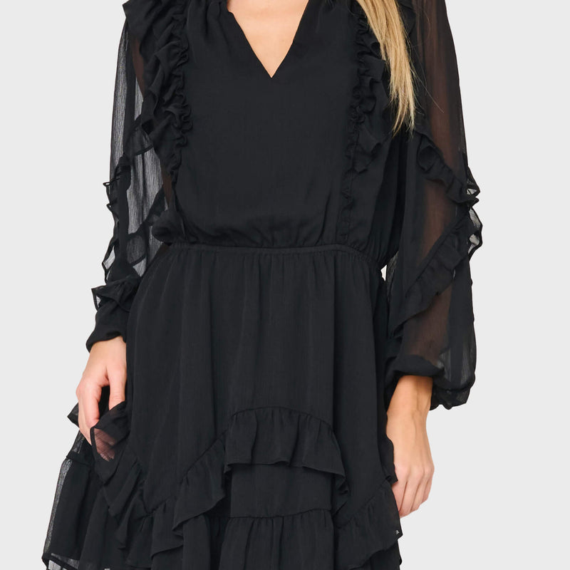 Woman modeling Chloe Ruffles For Days Dress in Black styled business casual