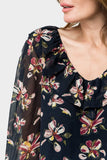 Close-up of Front of Woman wearing GIGI Blouson Sleeve V-Neck Top with Ruffle Trim in Navy Blossom Print