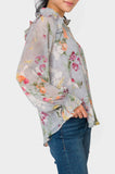 Side of Woman wearing Long Sleeve Ruffle Trim V-Neck Blouse in Dusky Blue Grey Floral Print
