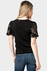 Back of Woman wearing Sequin Puff Sleeve V-Neck Top in Black