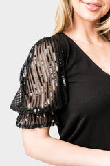 Close-up of Woman wearing Sequin Puff Sleeve V-Neck Top in Black