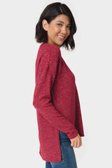 The Side of a Woman wearing a V-Neck Shimmer Tunic with High Low Hem Burgundy 