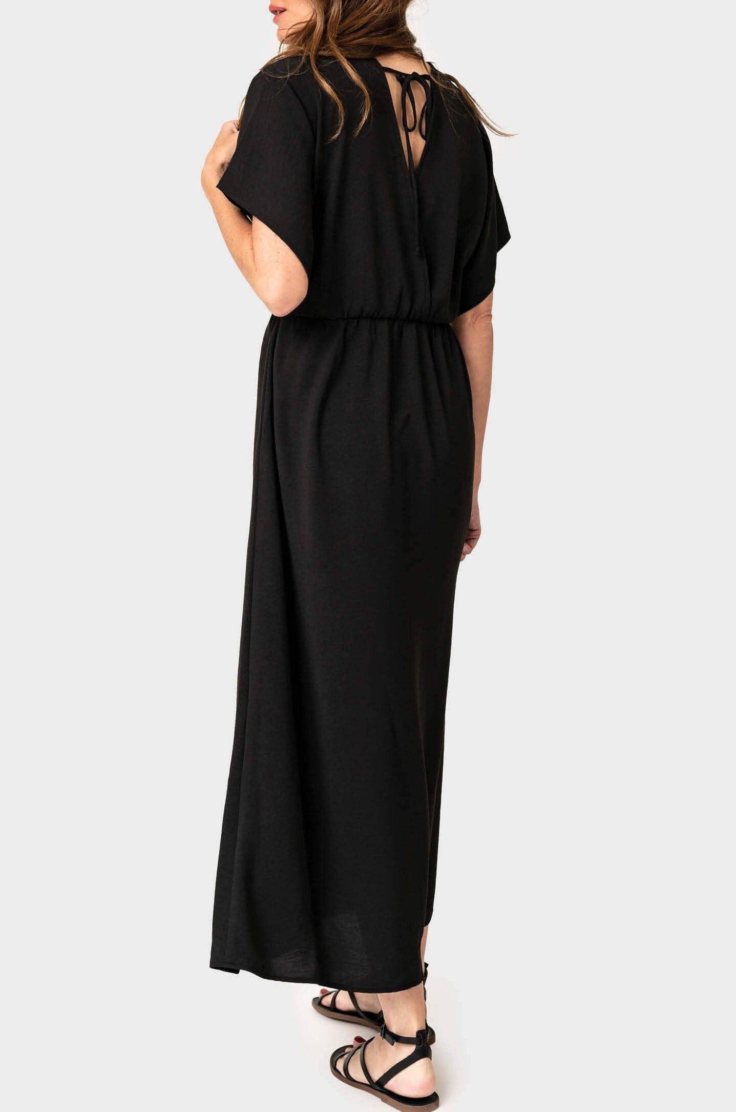 Back of Woman wearing Tie Back Surplice Dress in Black