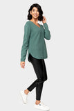 Side of Woman wearing V-Neck Ribbed Relaxed Sweater in Teal Pine