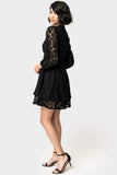 Side of WOman wearing Fit and Flare Lace Dress with Layered Skirt in Black
