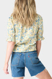Back of Woman wearing Blue Yellow Flax Dianthus Henley Puff Sleeve Blouse
