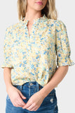 Close-up of Woman wearing Yellow Blue Flax Dianthus Henley Puff Sleeve Blouse
