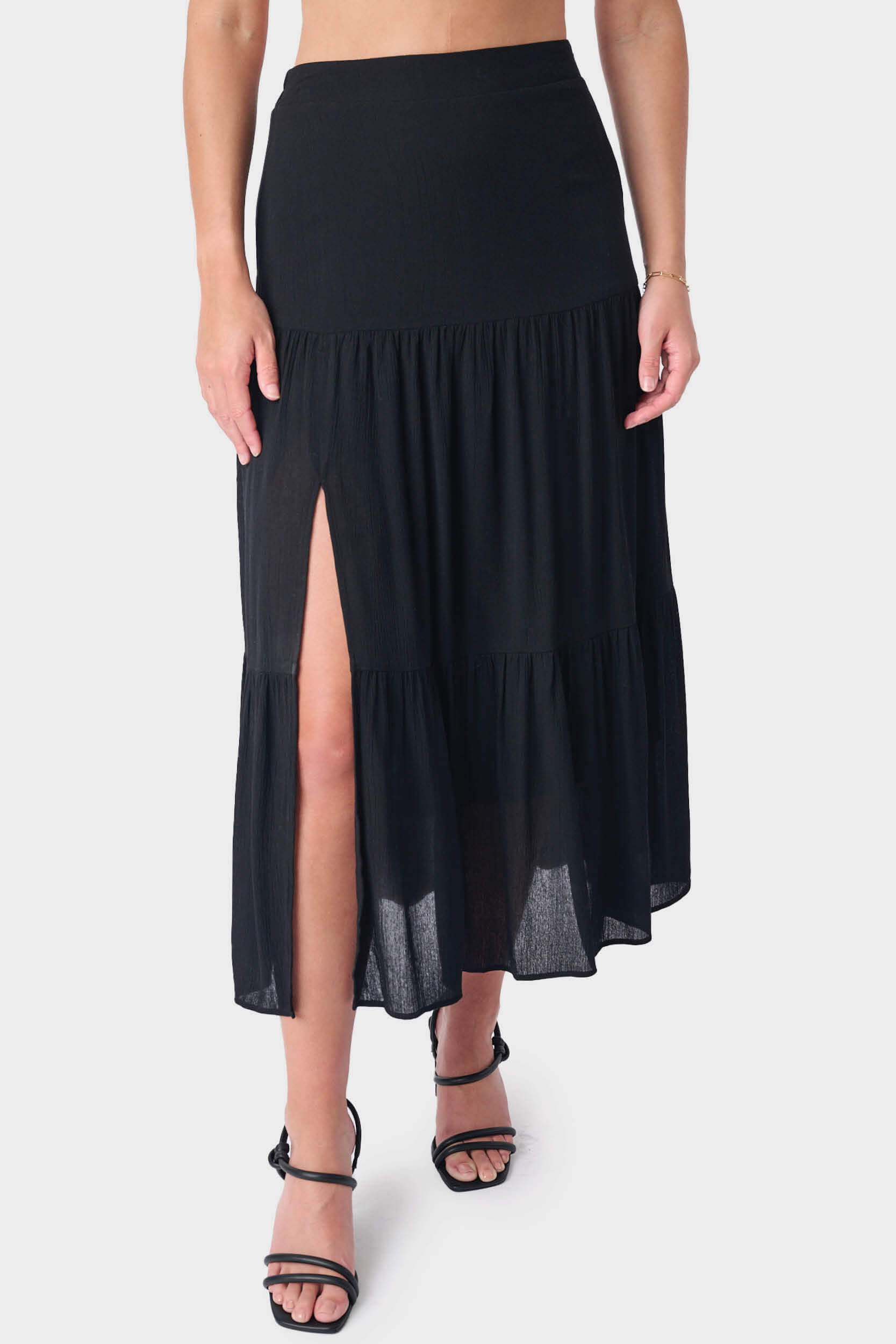 Close-up of Woman wearing Black Tiered Maxi Skirt With Offset Front Slit