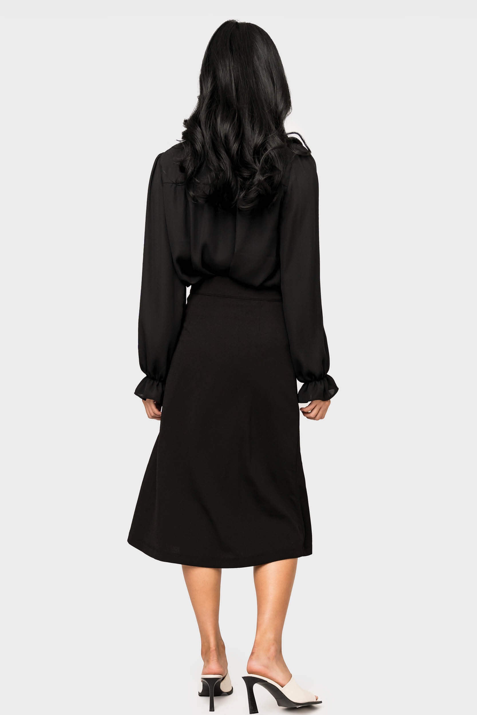 Back of Woman wearing Wrapped Up Skirt with Buckle in Black