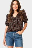 Front of Woman wearing Puff Sleeve V-Neck Blouse in Black Vine