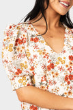 Close-up of WOman wearing Puff Sleeve V-Neck Blouse in Off White Floral