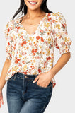 Front of Woman wearing Puff Sleeve V-Neck Blouse in Off White Floral