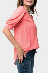 Side of Woman wearing Puff Sleeve V-Neck Blouse in Coral