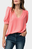 Front of Woman wearing Puff Sleeve V-Neck Blouse in Coral
