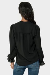 Back of Woman wearing Long Sleeve Blouse with Ruffled Cuff in Black