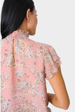 Back of Woman wearing Flutter Sleeve Smocked Neck Blouse in Rose Bouquet print