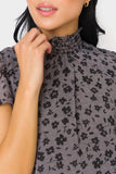 Close-up of Front of Woman wearing Flutter Sleeve Smocked Neck Blouse in Shadow Charcoal Flower